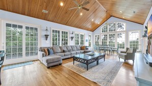 A spacious living room with a large sectional sofa, a coffee table, and a ceiling fan. - Oceans Rest Private Pool, luxury living in DeBordieu 7 bedrooms (Georgetown)