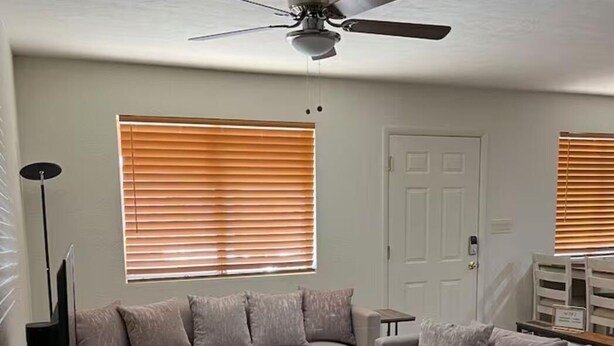A living room with a sofa, coffee table, and a ceiling fan. - Heartwarmin "little big" home! (Rio Rico)