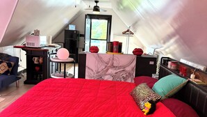 A cozy bedroom with a red bed, a ceiling fan, and a desk with a computer and a lamp. - 3BR Retreat in a House 2Floor (Yorkville)