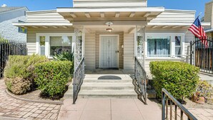 A two-story house with a front porch, a garage, and a driveway.