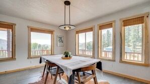 A dining area with a table, chairs, and a hanging light fixture. - Republic Retreat w/ Mountain Views & Soaking Tub (Republic)