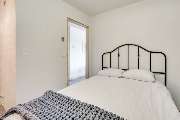 A bedroom with a bed, a gray knitted blanket, and a white pillow. - Republic Retreat w/ Mountain Views & Soaking Tub (Republic)