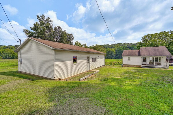 A single-story, white wooden building with a porch and a small attached structure. - 4 Mi to Ohio River: Quiet Guest House w/ Yard! (Belpre)