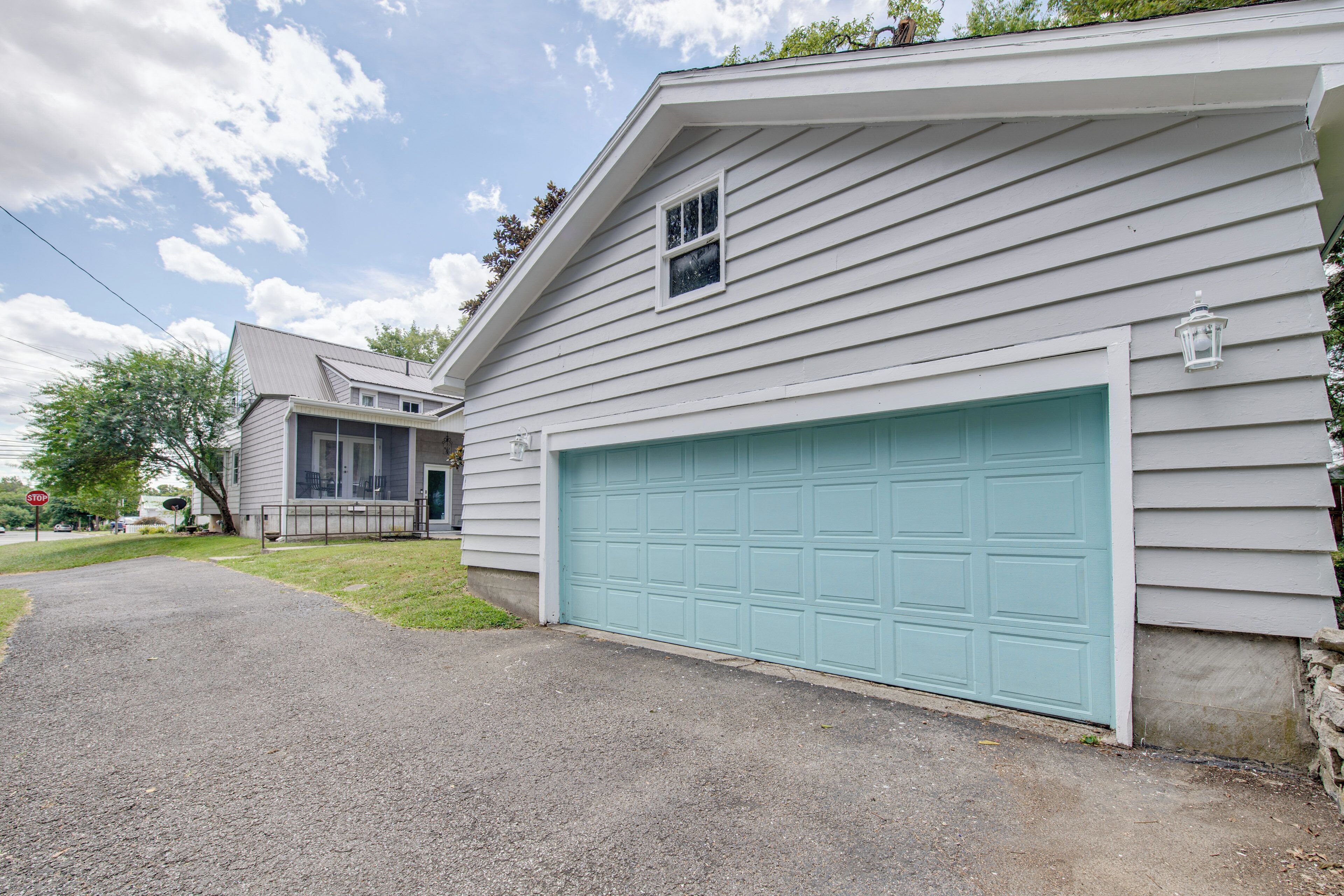 A residential house with a garage, a covered porch, and a driveway.