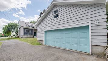 A residential house with a garage, a covered porch, and a driveway.