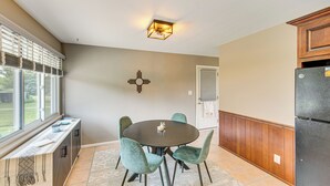 A kitchen with a dining table, chairs, a refrigerator, and a window with blinds. - Near Dtwn Harrisburg: Stylish Home w/ Patio & Yard (Camp Hill)