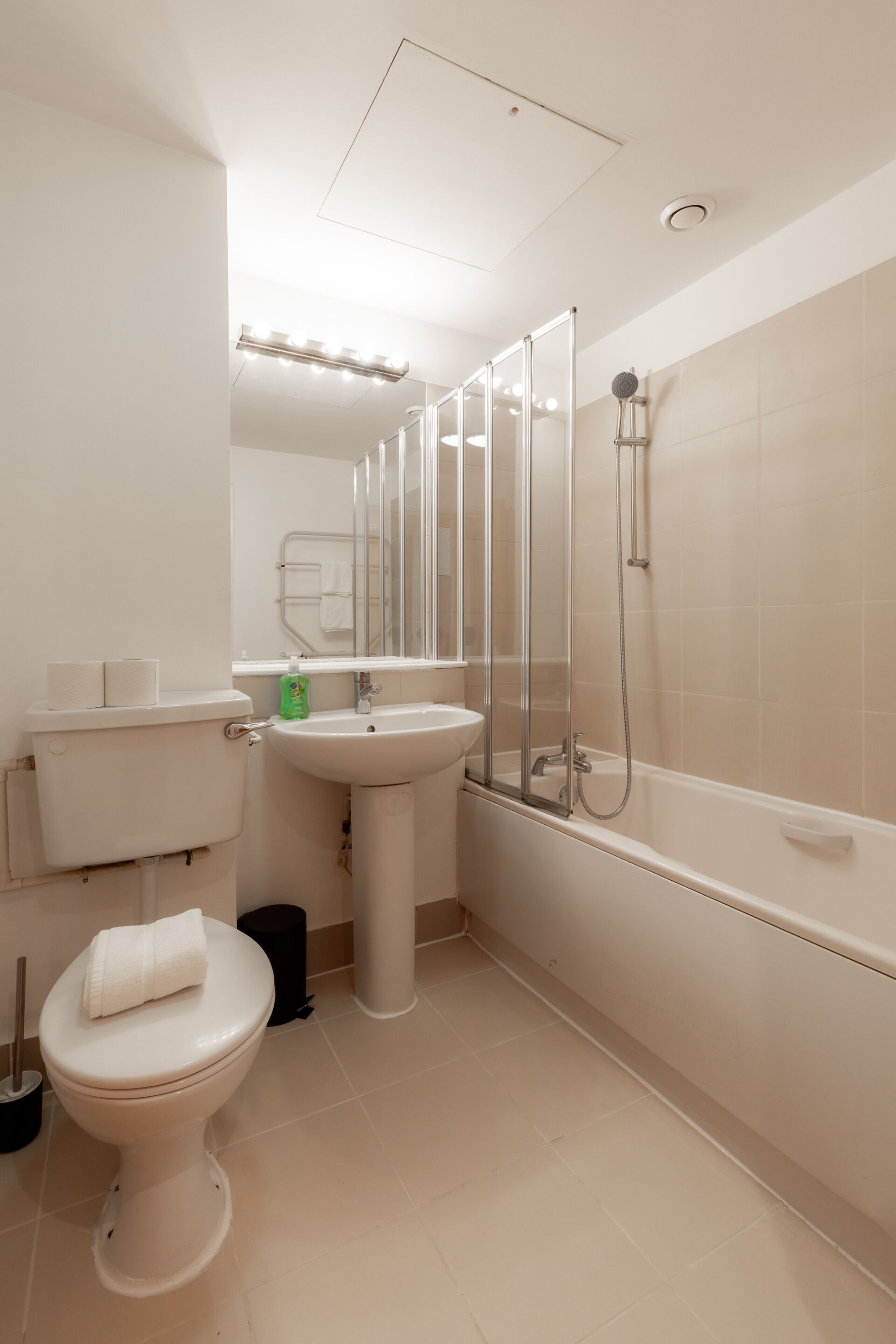 A modern bathroom with a toilet, sink, and shower.