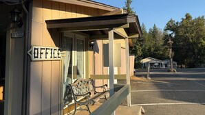 A small building with a porch and a bench, labeled "OFFICE" on the side. - Columbia Inn Motel CA 49 (Columbia)