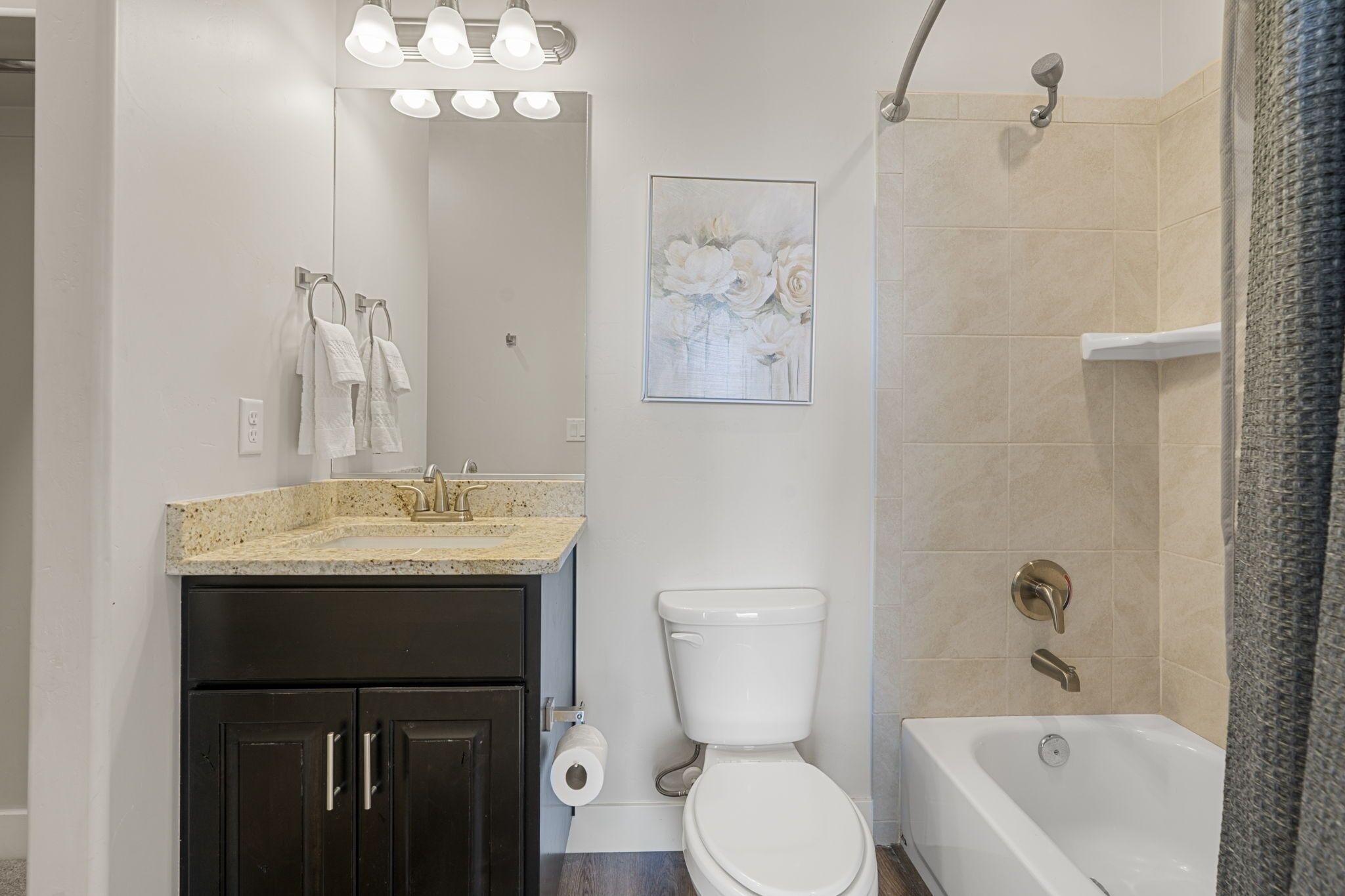 A bathroom with a sink, toilet, and bathtub.