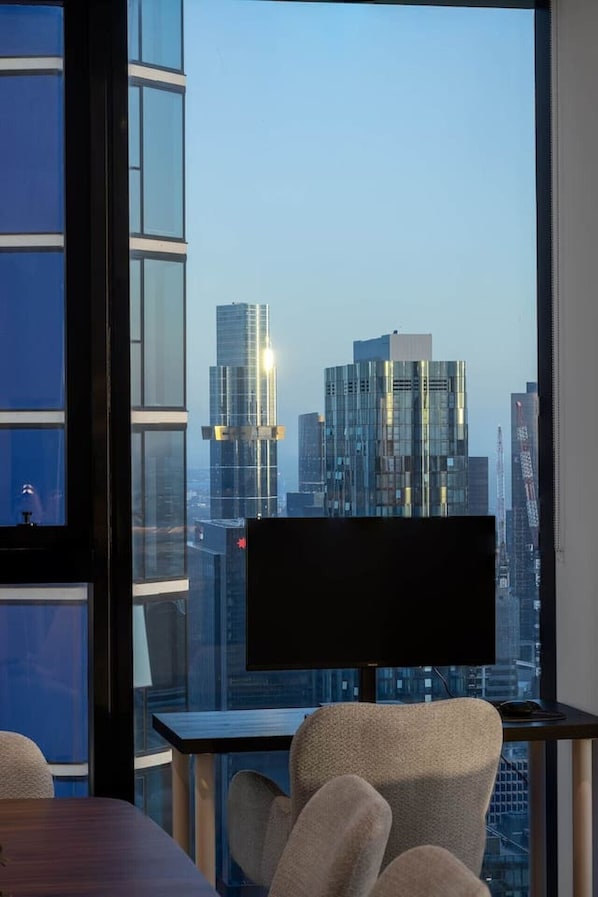 A modern office space with a large window overlooking a cityscape.