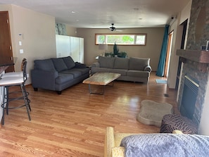 House, Multiple Beds, Patio, Garden View (2765 27th CT SW) | Living area | 55-inch flat-screen TV with digital channels, fireplace