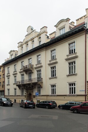 A multi-story building with a classical architectural style, featuring ornate balconies and a prominent entrance.