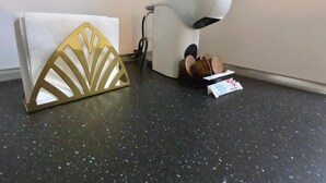 A kitchen counter with a white appliance, a decorative gold item, and a package of sugar. - Valdecanillas 1 bedroom (Madrid)