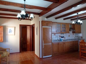Stovetop, coffee/tea maker, cookware/dishes/utensils, dining tables