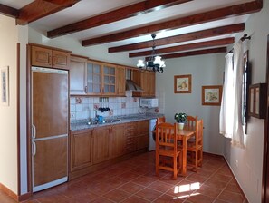 Stovetop, coffee/tea maker, cookware/dishes/utensils, dining tables