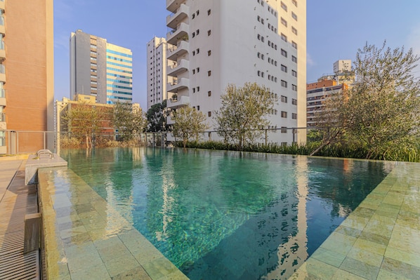 Outdoor pool, open 7:00 AM to 10:00 PM, pool umbrellas, pool loungers