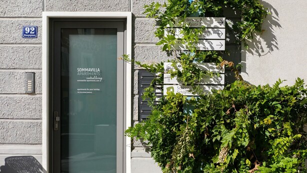 A building entrance with a door labeled 'SOMMAVILLA APARTMENTS' and directional signs for various locations. - Studio 'Sommavilla - Small' with Mountain View and Wi-Fi (Silandro)