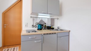 A compact kitchen with a sink, countertop, and cabinets. - Studio 'Sommavilla - Small' with Mountain View and Wi-Fi (Silandro)