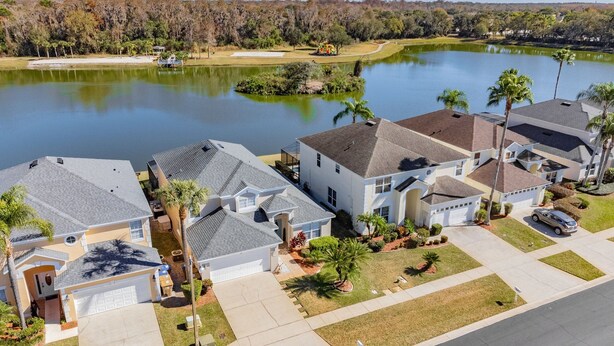 A residential area with houses, a lake, and a golf course. - 5BR Lake Berkley Home, Lake-View Pool (Kissimmee)