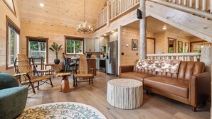 A spacious wooden cabin interior with a living area, kitchen, and a balcony. - NEW Luxury Cabin w/ Views*Private Pool*Game Room*Hot Tub (SEVIERVILLE)