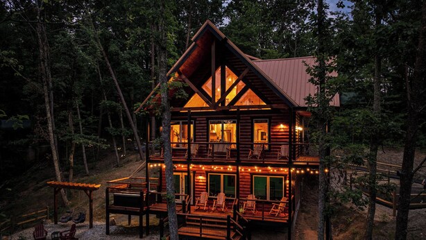 A multi-level log cabin with a deck, outdoor seating, and a fire pit. - NEW Luxury Cabin w/ Views*Private Pool*Game Room*Hot Tub (SEVIERVILLE)