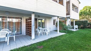 A modern two-story house with a covered patio, outdoor seating, and a well-maintained lawn. - Apartment - Terrasses De L'Océan with Shared Pool, Wi-Fi, and Air Conditioning (MOLIETS et MAA)