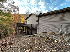 A two-story building with a deck and a garage. - Spacious Mtn Chalet - Hot Tub & Minutes from Slopes, Trails, & Wineries (McGaheysville)