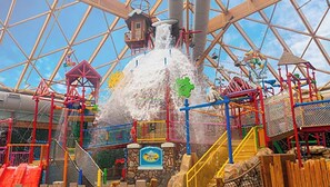 A water ride with a large water tower, a bridge, and various play structures.