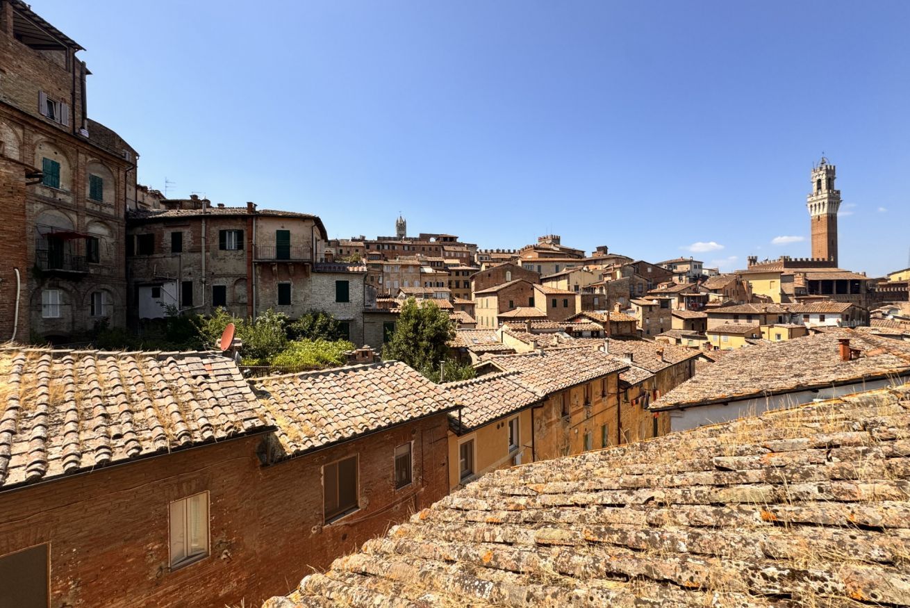 A historic town with terracotta-tiled rooftops and traditional architecture.