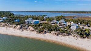 A coastal property with multiple buildings, a beach, and a view of the ocean. - Villa Laguna (Port St. Joe)