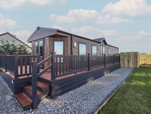 A modern mobile home with a wooden deck and a gravel pathway. - Meadows Park 5 (Hull)