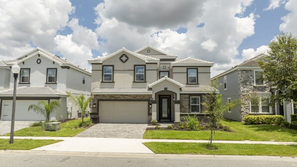 A residential neighborhood with multiple houses featuring similar architectural styles, including gabled roofs and front entryways with garage doors.