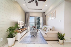 Deluxe Apartment, 3 Bedrooms, Balcony, City View | Living area | 55-inch flat-screen TV with cable channels, Netflix, streaming services