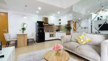 Deluxe Apartment, 2 Bedrooms, Balcony, City View | Living area | 55-inch flat-screen TV with cable channels, Netflix, streaming services