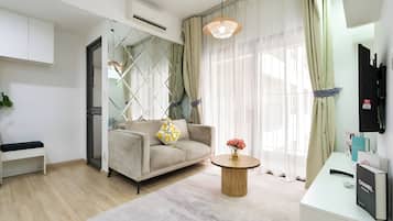 Deluxe Apartment, 2 Bedrooms, Balcony, City View | Living area | 55-inch flat-screen TV with cable channels, Netflix, streaming services