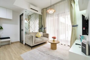 Deluxe Apartment, 2 Bedrooms, Balcony, City View | Living area | 55-inch flat-screen TV with cable channels, Netflix, streaming services