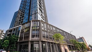 A modern high-rise building with a glass facade and a corner entrance. - Cherry Houses - Masteri Thao Dien (Ho Chi Minh City)