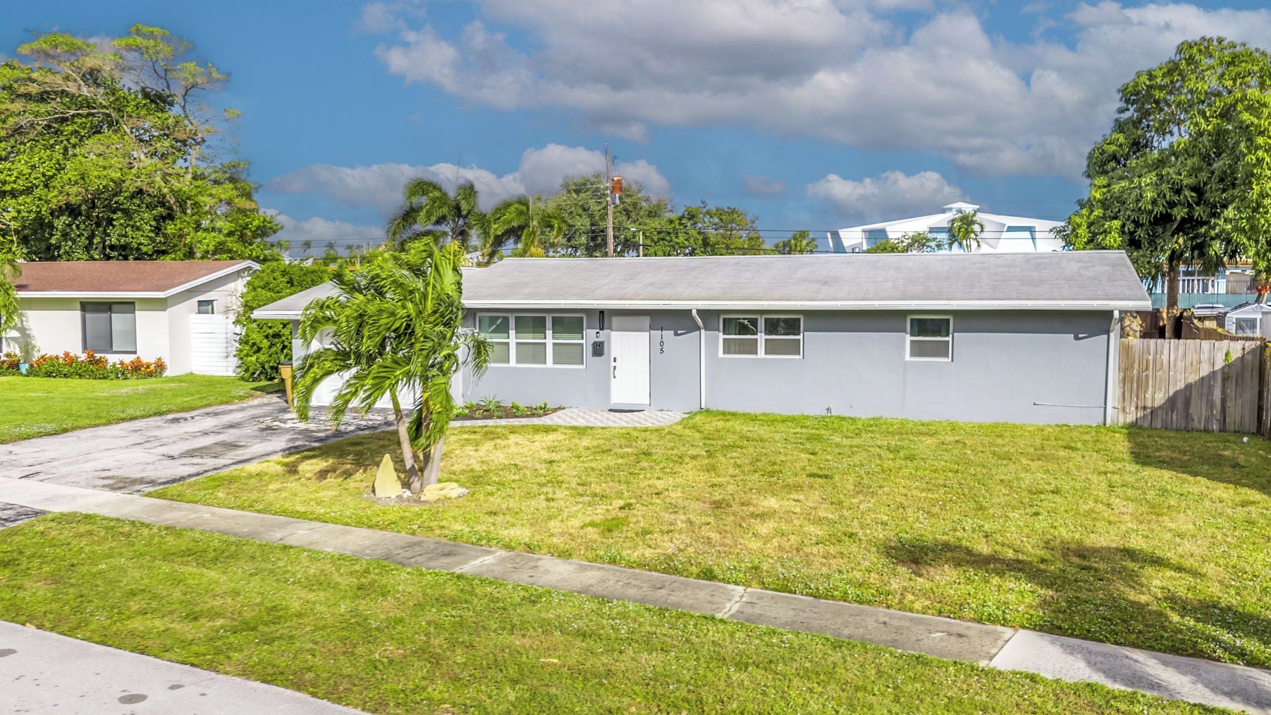 A single-story house with a front yard, a mailbox, and a number '105' on the door.