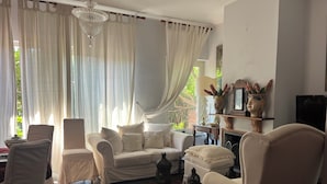 A living room with a sofa, armchairs, a coffee table, and a fireplace. - Elegant Sicilian villa in the heart of Taormina - 3 bedrooms, 3 bathrooms. (Taormina)