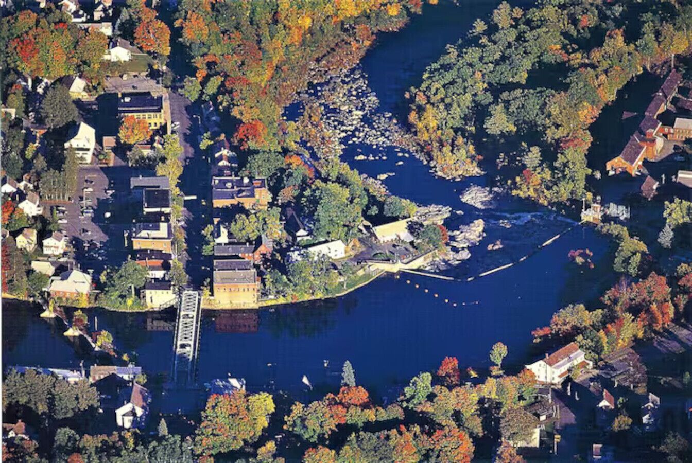 An aerial view of a waterfront area with buildings, a bridge, and a dock.