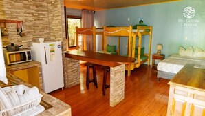 A compact hotel room with bunk beds, a kitchenette, and a dining area. - Hotel Rio Celeste Dreams (Bijagua)
