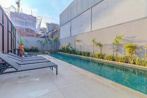 Outdoor pool, open 7:00 AM to 10:00 PM, pool loungers