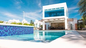 A modern building with a pool in front.