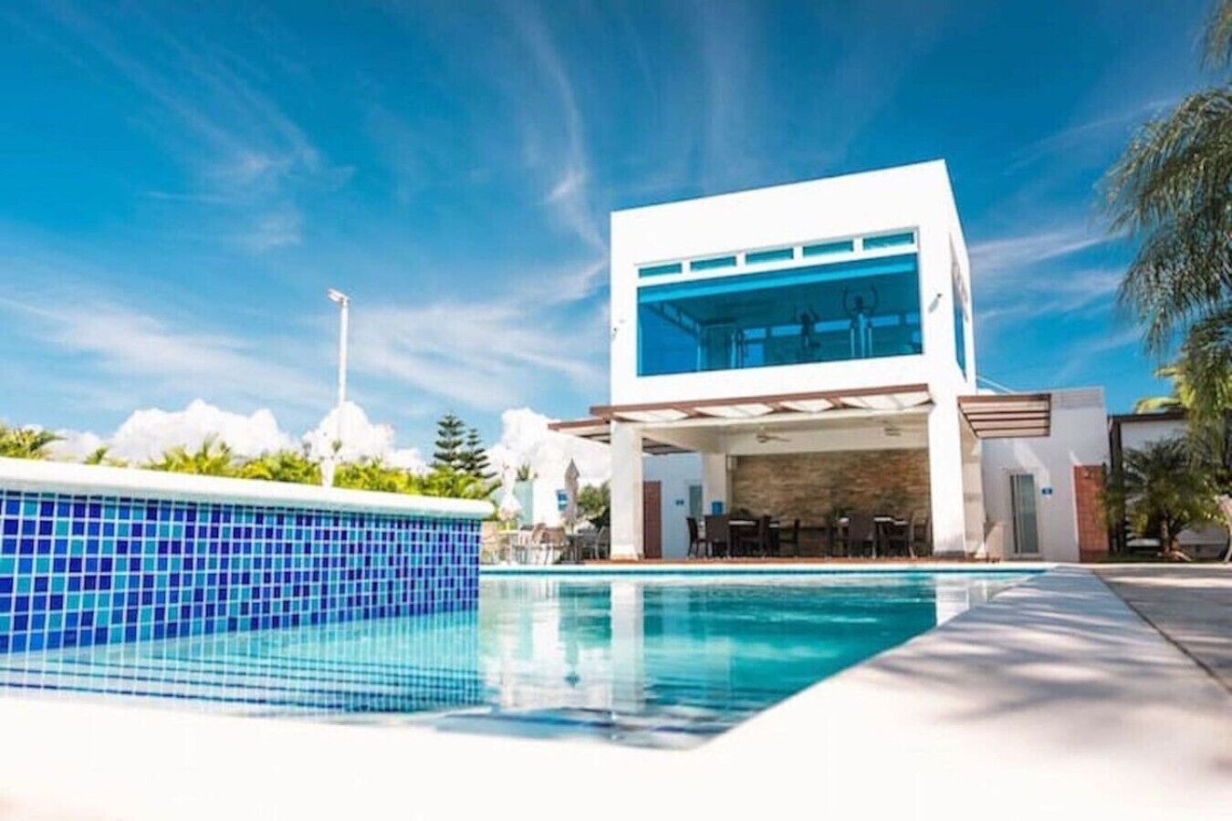 Um edifício moderno com piscina em frente.