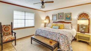 A bedroom with a bed, a chair, a table, a ceiling fan, and a window. - Healthcare-Worker Hub 2 Mi to Texarkana Hospitals! (Texarkana)
