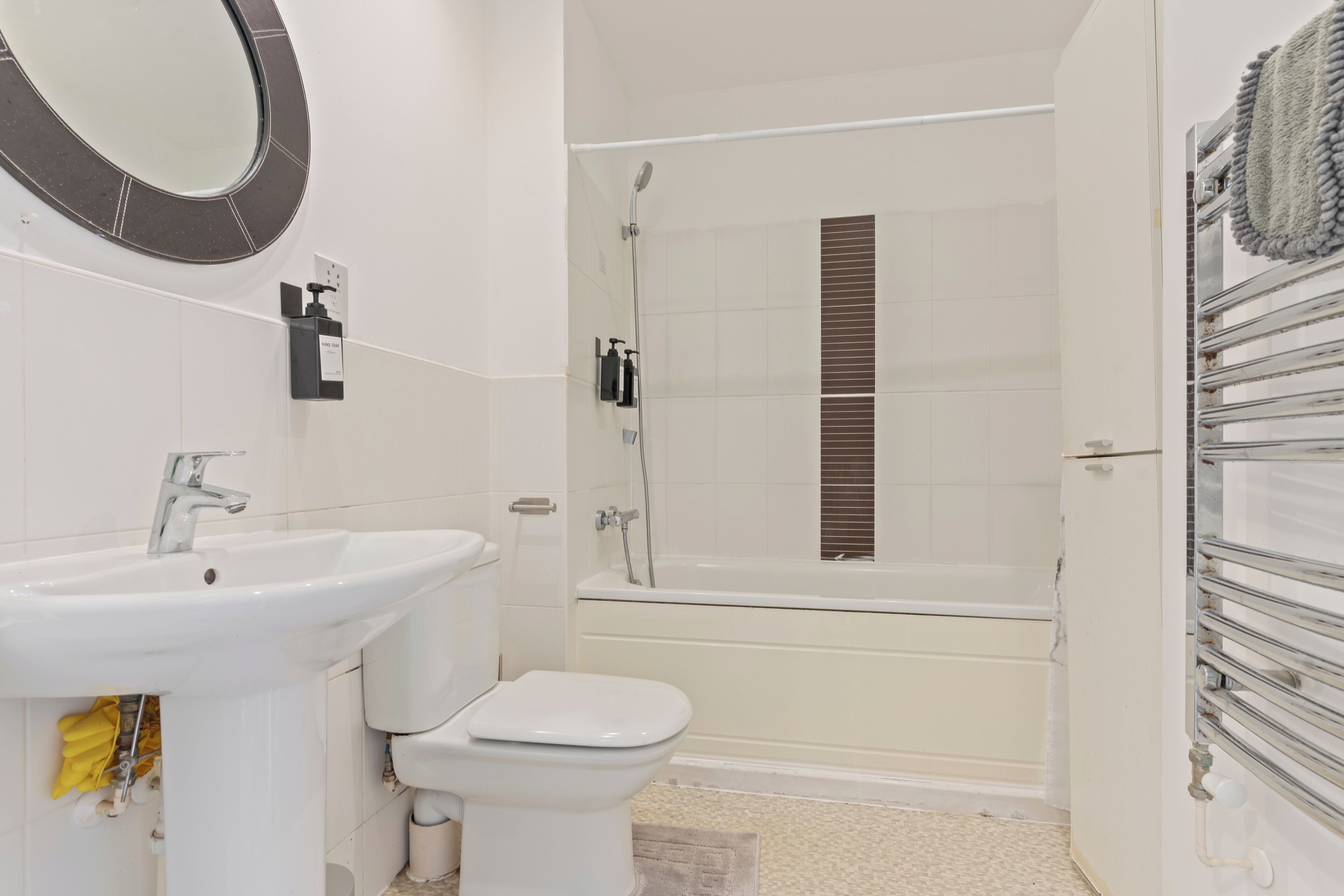 A bathroom with a sink, toilet, and bathtub.