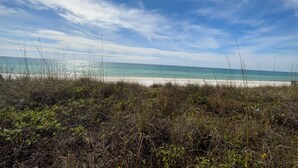 A beach with clear skies and sunlight. - Fully renovated! Great rates on a charming 2/2 steps from the beach! (Santa Rosa Beach)