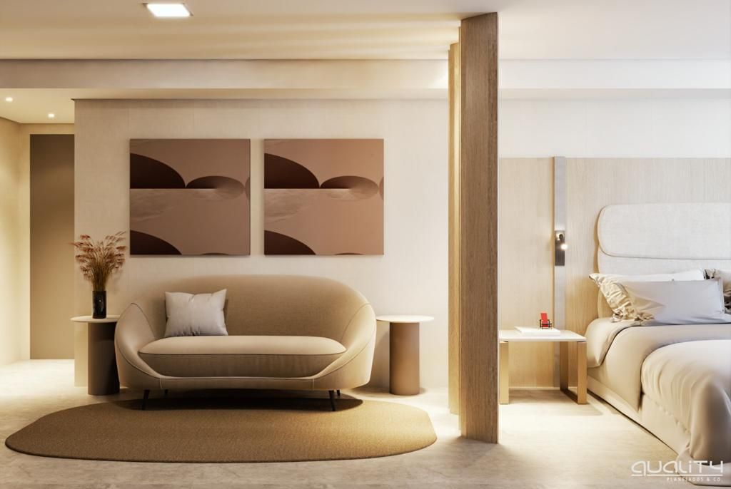 A modern hotel room with a sofa, a bed, a round rug, and two wall-mounted artworks.