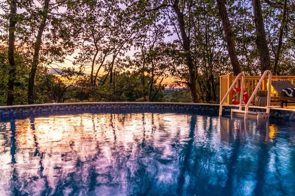 Unwind on the shaded deck w/ cozy seating surrounded by forest views