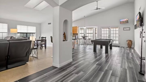 A spacious living area with a pool table, a sofa, and a dining area with chairs. - 3BR Spacious Scottsdale Home w/ Hot Tub & Pool! (Scottsdale)